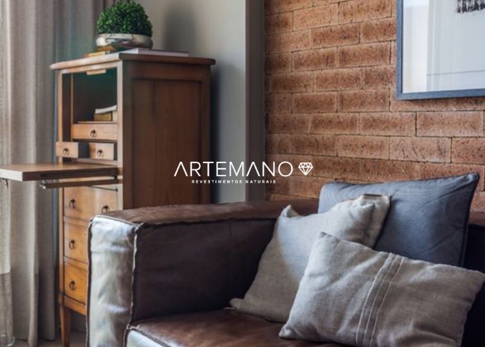 Sala de estar com tom marrom predominante combinando perfeitamente com o tijolo revestindo a parede.